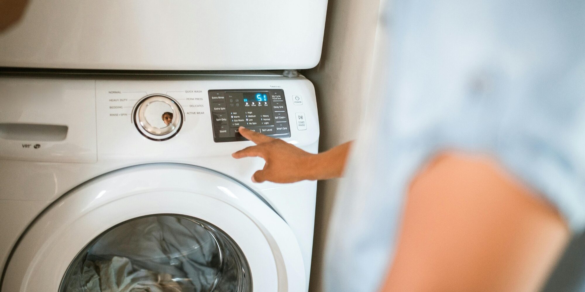 Appliance repair engineer diagnosing washing machine fault in Birmingham