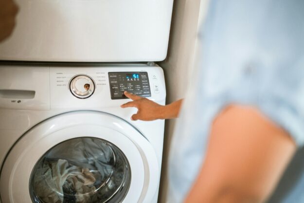 Appliance repair engineer diagnosing washing machine fault in Birmingham Appliance repair engineer diagnosing washing machine fault in Birmingham